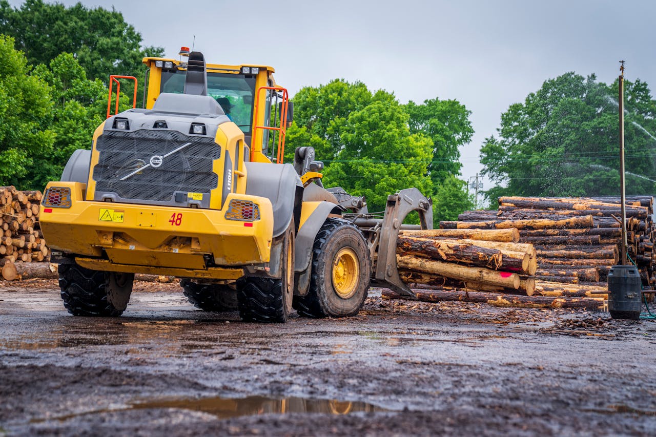A Tractor Lifting the Tree Logs